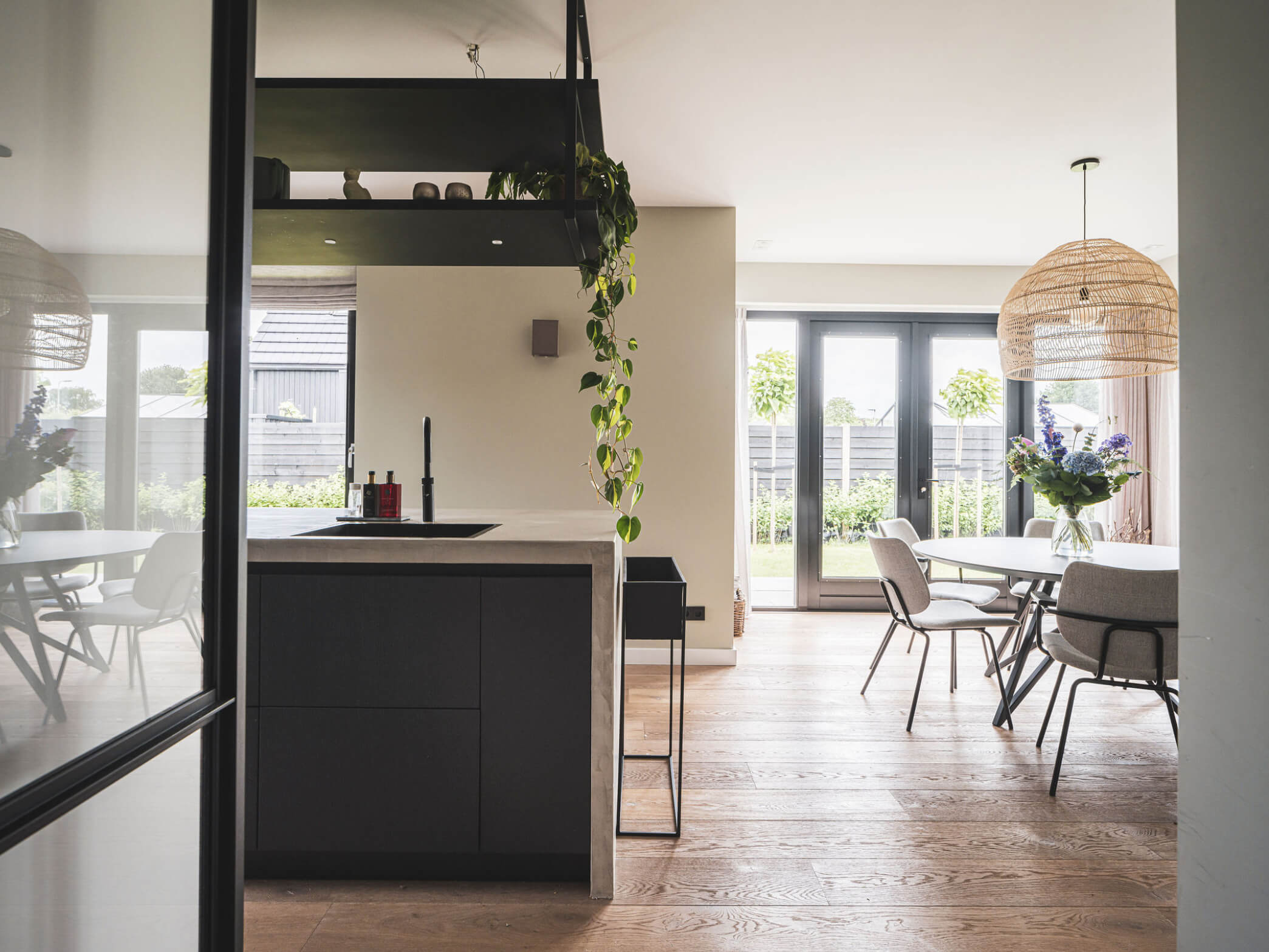 Doorzicht vanuit de keuken naar de dubbele tuindeuren bij de eethoek
